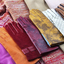 Several pairs of colorful fashionable ladies gloves on display.