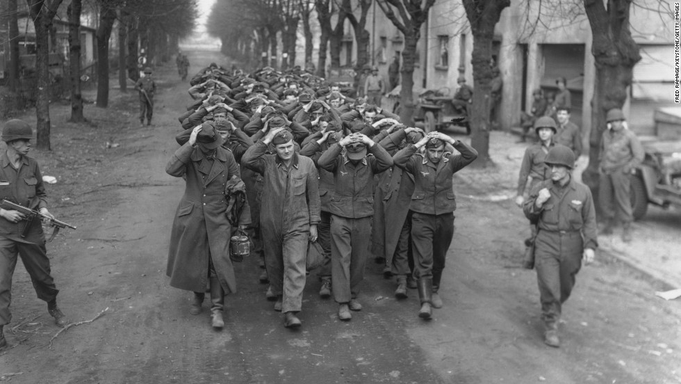 German prisoners captured at Friedrichsfeld march through a town in Germany after the crossing of the Rhine River by the U.S. 9th Army on March 26, 1945.