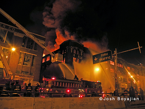 firefighters work at nighttime fire