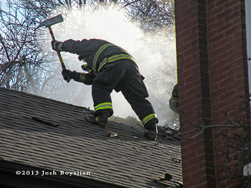 firefighter with axe on the roof