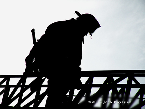 firefighter silhouette on ladder