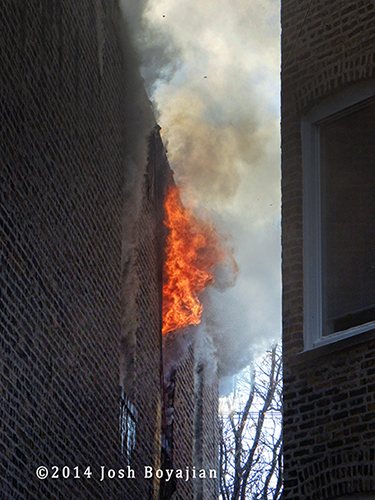 flames shoot out upper floor window