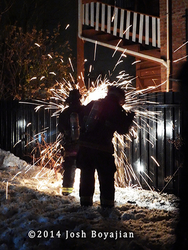 firemen cut steel fence at night