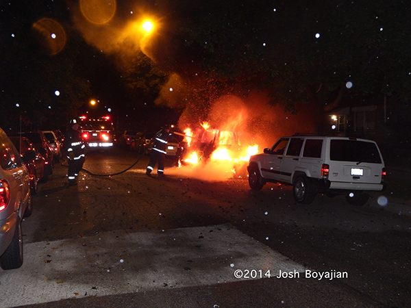 car engulfed in flames at night