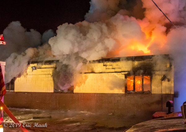 truck repair shop engulfed in flames