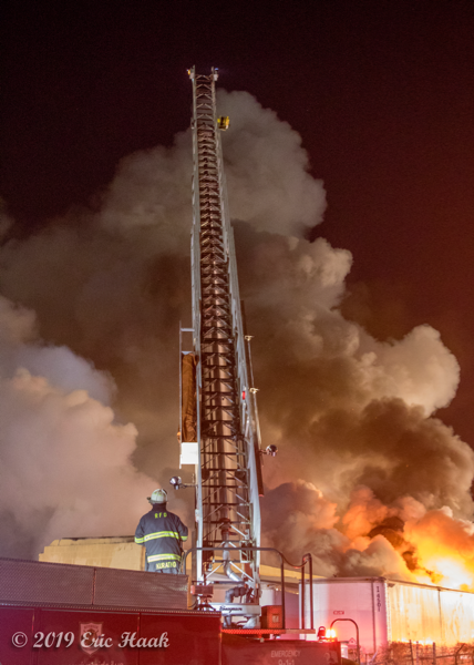 elevated master stream battles nighttime fire