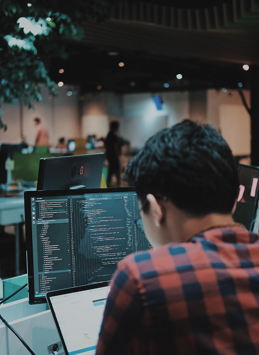 Man sitting at laptop coding