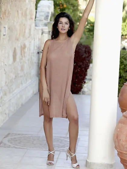 With her intense gaze fixed on you, Adelle strips in public