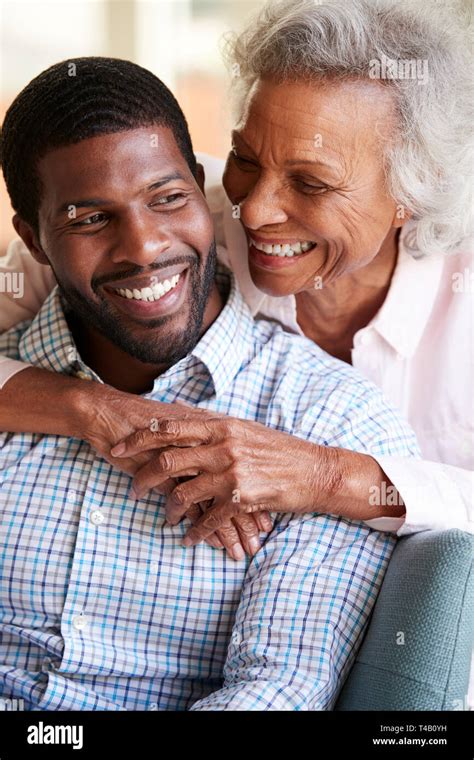 Smiling Senior Mother Hugging Adult Son At Home Stock Photo - Alamy