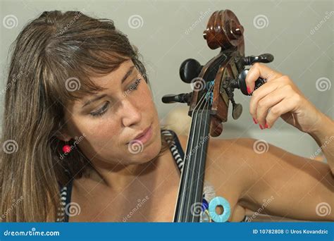 Girl Tuning a violoncello stock photo. Image of lady - 10782808