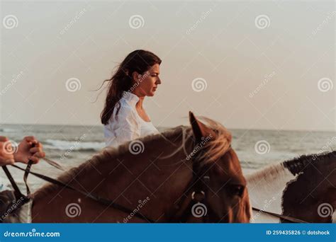 Woman in Summer Clothes Enjoys Riding a Horse on a Beautiful Sandy ...