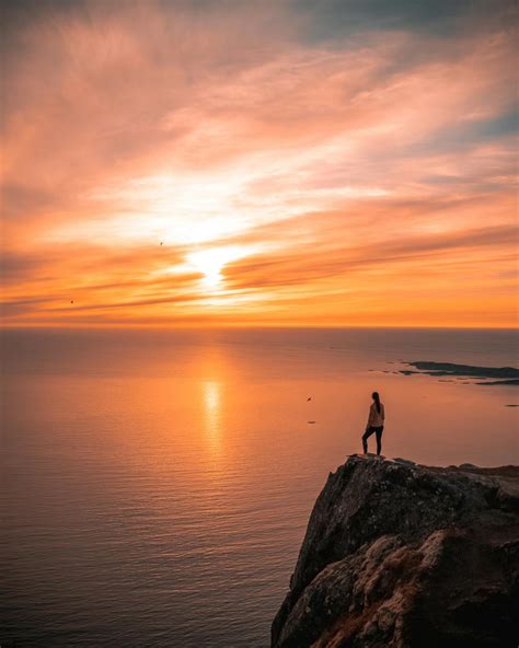 Man Standing On Cliff During Sunset · Free Stock Photo