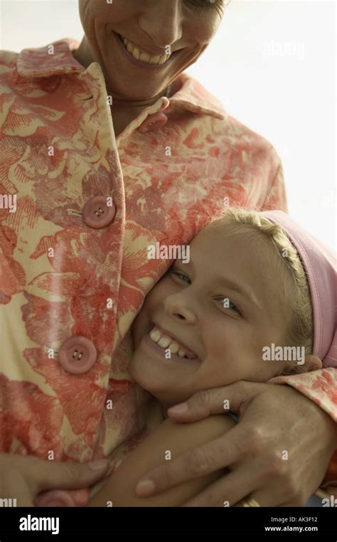 Mother hugging her daughter Stock Photo - Alamy