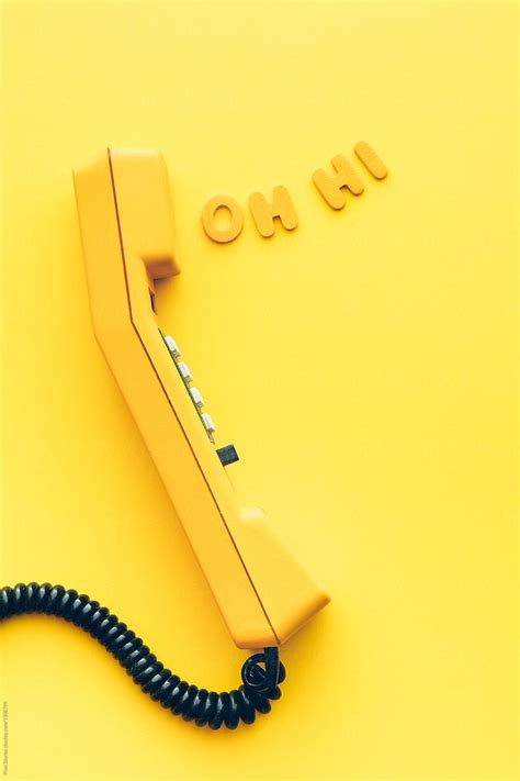 "Old Yellow Phone With Greeting Coming Out From Earpiece" by Stocksy Contributor "Pixel Stories ...