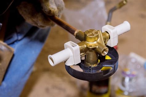 Premium Photo | Soldering brass fitting on copper pipe with torch of welding on water system.