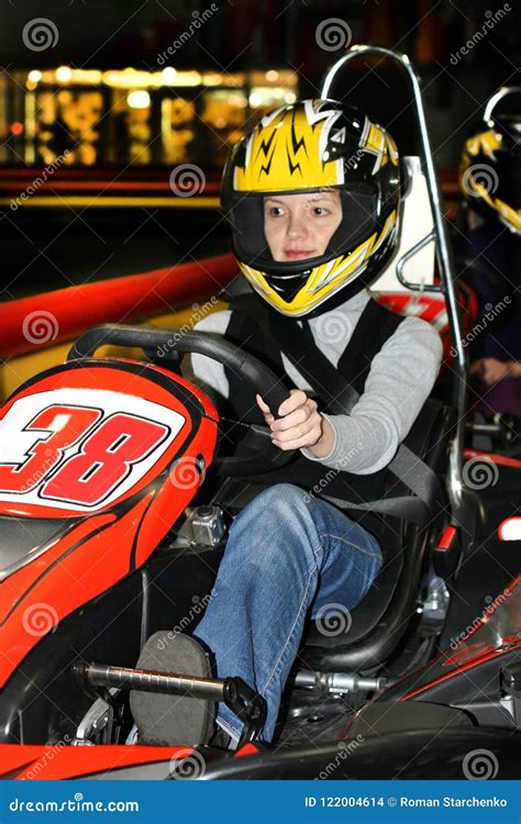 A Young Woman in a Helmet in a Go-kart on the Karting Track Indoors Editorial Stock Image ...