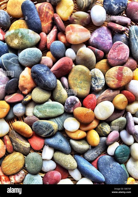 Pile of bright and colourful river pebbles Stock Photo - Alamy