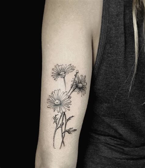 Daisies tattoo on the triceps - Tattoogrid.net