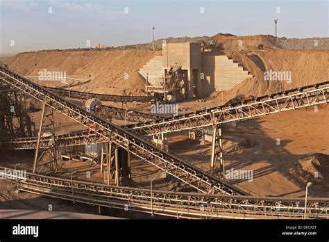 Ore conveyors and crusher on open pit surface gold mine processing Stock Photo: 60520176 - Alamy