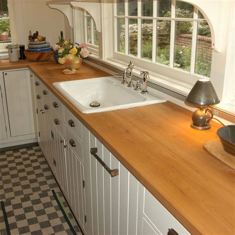 Dense reclaimed elm wood countertops provide great durability and a soft natural color tone that ...