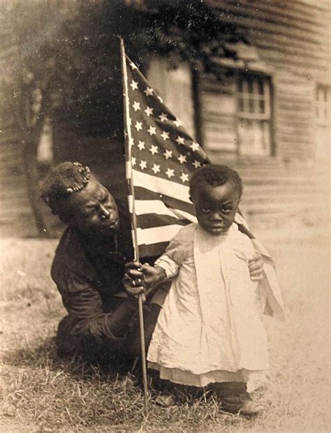 African American mother and child holding an American flag… | Flickr