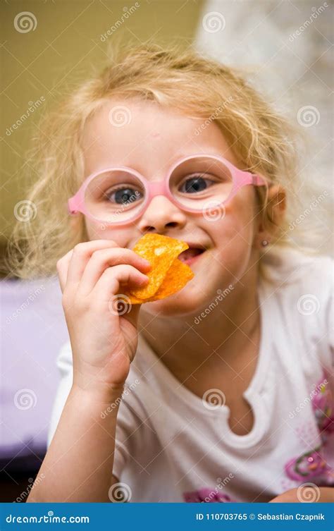 Young Girl Eating Chips Making Funny Face Stock Image - Image of eyed, caucasian: 110703765