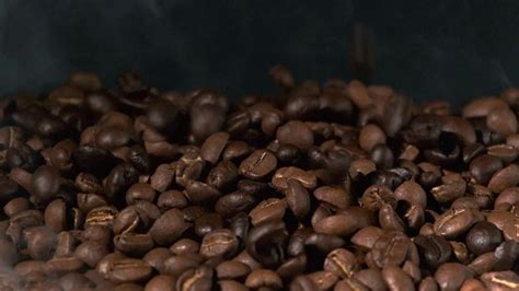 Slow motion of roasted coffee beans falling. 23712201 Stock Video at Vecteezy