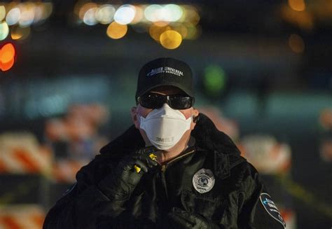 Allied Universal Security officer Jeff Reinharcz guards the entrance to a temporary shelter for