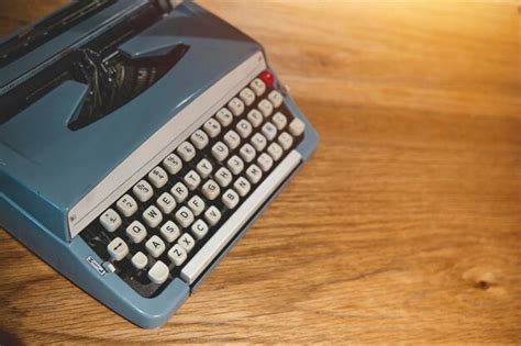 Premium Photo | Retro old typewriter on blur background and front of wooden table vintage concept