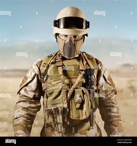 Photo of a fully equipped soldier in uniform, armor, helmet and glasses ...