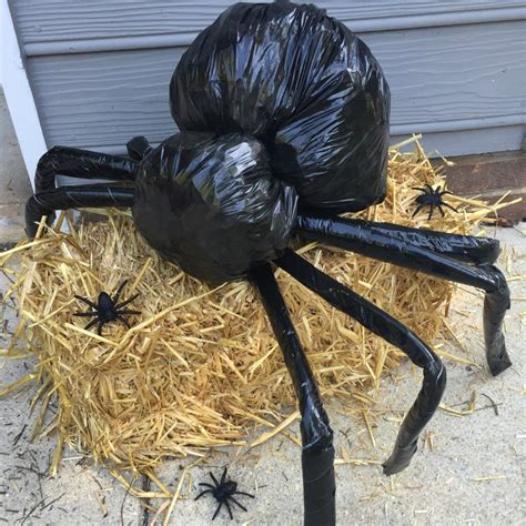 Step-by-step instructions for making a giant Halloween spider out of trash bags, coat hanger ...