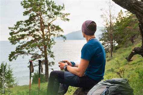 Hiking climbing cliff adventure. Backpacker man resting after hiking ...