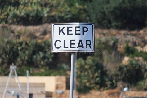 Keep Clear Road Sign in Blue Sky Background, Vertical. Stock Image - Image of white, rusty ...