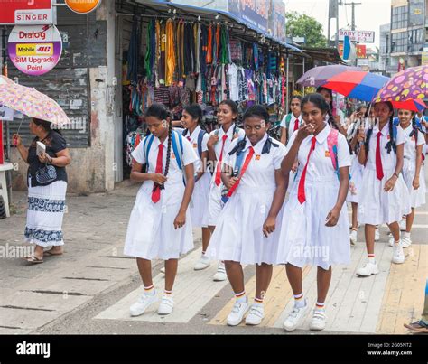 Sri lankan schoolgirls in white school uniform walk through town after ...