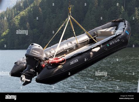 Empty inflatable zodiac boat being hoisted onto ship hi-res stock photography and images - Alamy