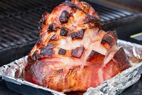 Delicious double-smoked and maple-glazed ham is a super simple pellet-grill recipe that is one ...