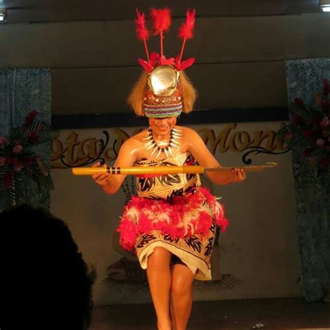 a woman is walking on the runway with a stick in her hand and wearing ...