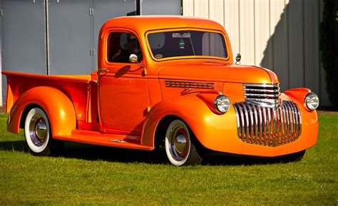 Neat vintage Chevrolet truck in bright orange Photograph by Eti Reid