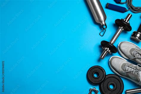 Gym equipment on light blue background, flat lay. Space for text Stock Photo | Adobe Stock