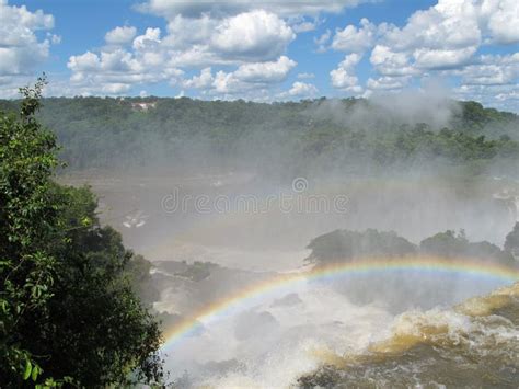 Rainbow and Iguazu Falls stock image. Image of blue, falls - 18416471