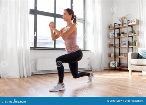 Young Woman Exercising at Home Stock Image - Image of home, fitness: 202245587