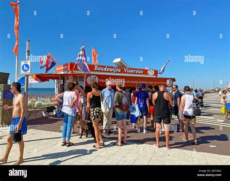 Zandvoort, Netherlands - August 12. 2022: Dutch waterfront promenade with typical fish sale ...