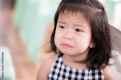 Close Up portrait of upset Asian adorable little girl. Cute child is crying pout her mouth ...