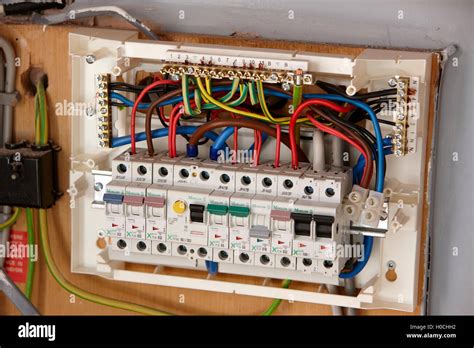 exposed wiring in domestic consumer unit circuit breaker in the uk Stock Photo - Alamy