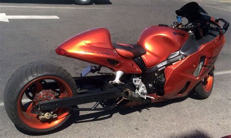 an orange motorcycle parked in a parking lot