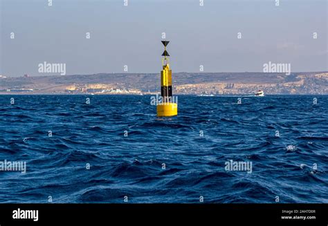 Navigational floating buoy - West cardinal mark - in Mediterranean sea Stock Photo - Alamy