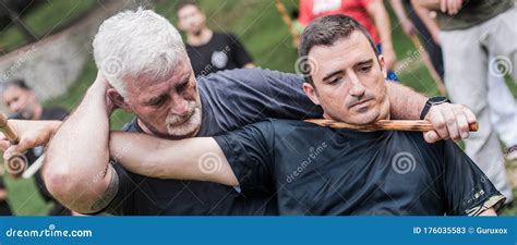 Filipino Escrima Instructor and Student Practice Stick Fight Choke Techniques Stock Image ...