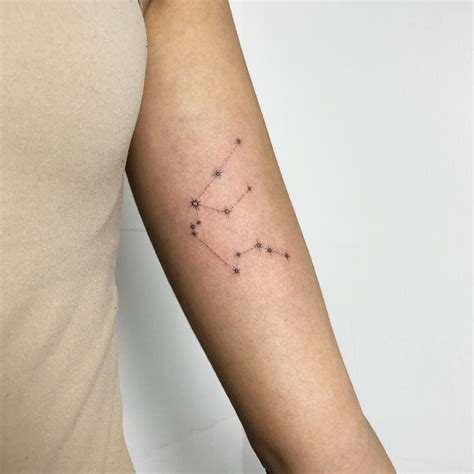 Aquarius Constellation Tattoo on Arm by Dominika Jendrasik