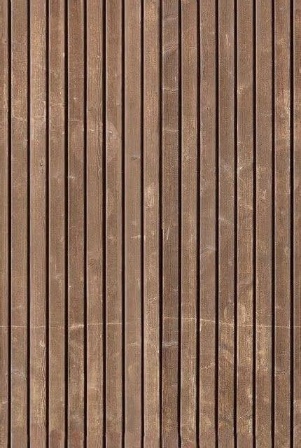 a brown wooden wall with vertical lines painted on it