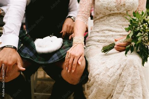 Groom wearing scottish kilt and bride wearing vintage wedding dress at ceremony Stock Photo ...